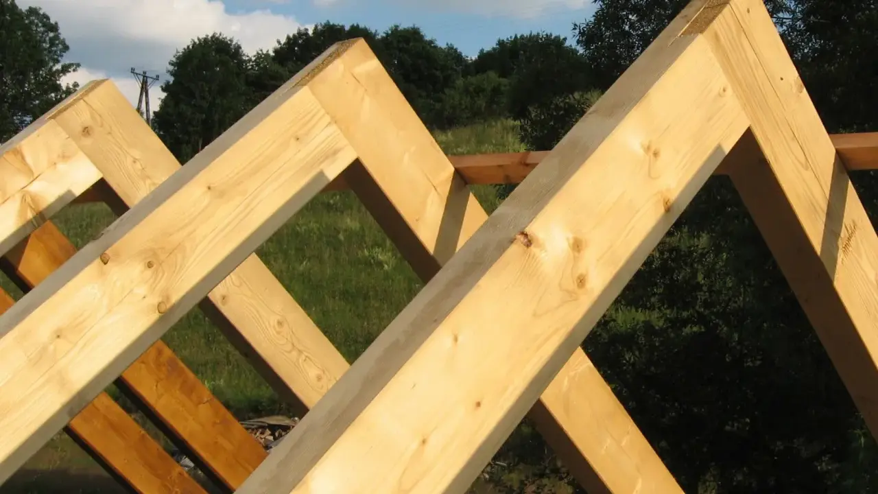 Drewniana konstrukcja dachu z widoczną krokwią kalenicową, gotowa do pokrycia.