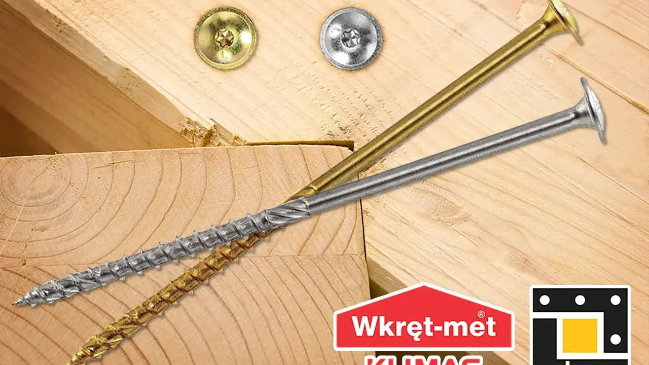 Dwa wkręty do krokwi, złoty i srebrny, leżą na drewnianych belkach. Logo "Wkręt-met KLIMAS" i "dmx".