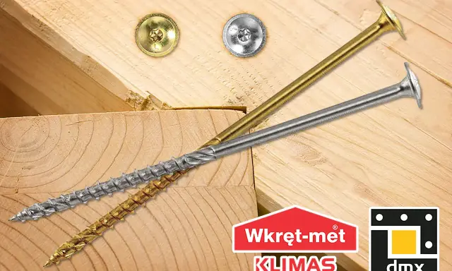 Dwa wkręty do krokwi, złoty i srebrny, leżą na drewnianych belkach. Logo "Wkręt-met KLIMAS" i "dmx".